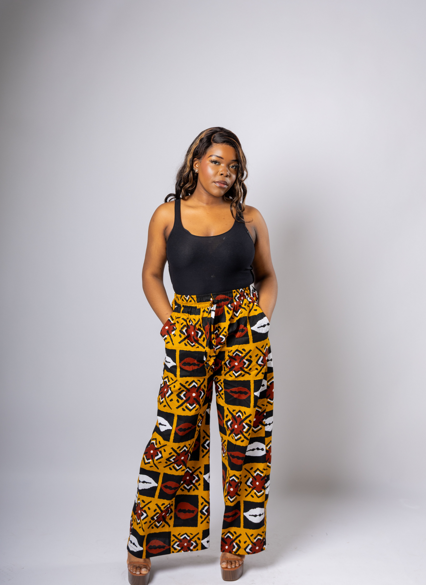 High-waist wide-leg trousers in vibrant Ankara print with red, white, and black detailing