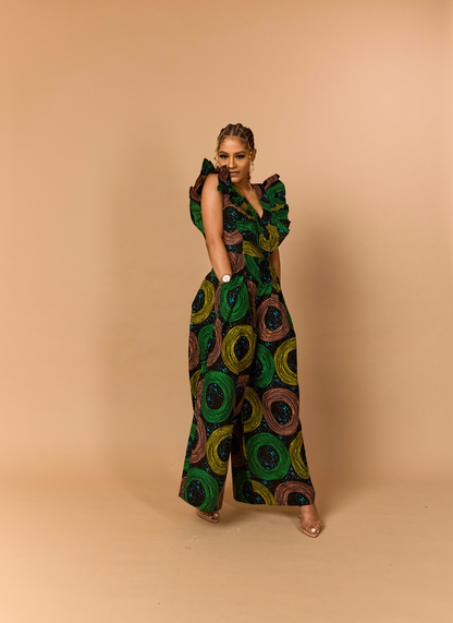 Showing the drape and comfort of a 100% cotton African wax print jumpsuit in a studio setting.