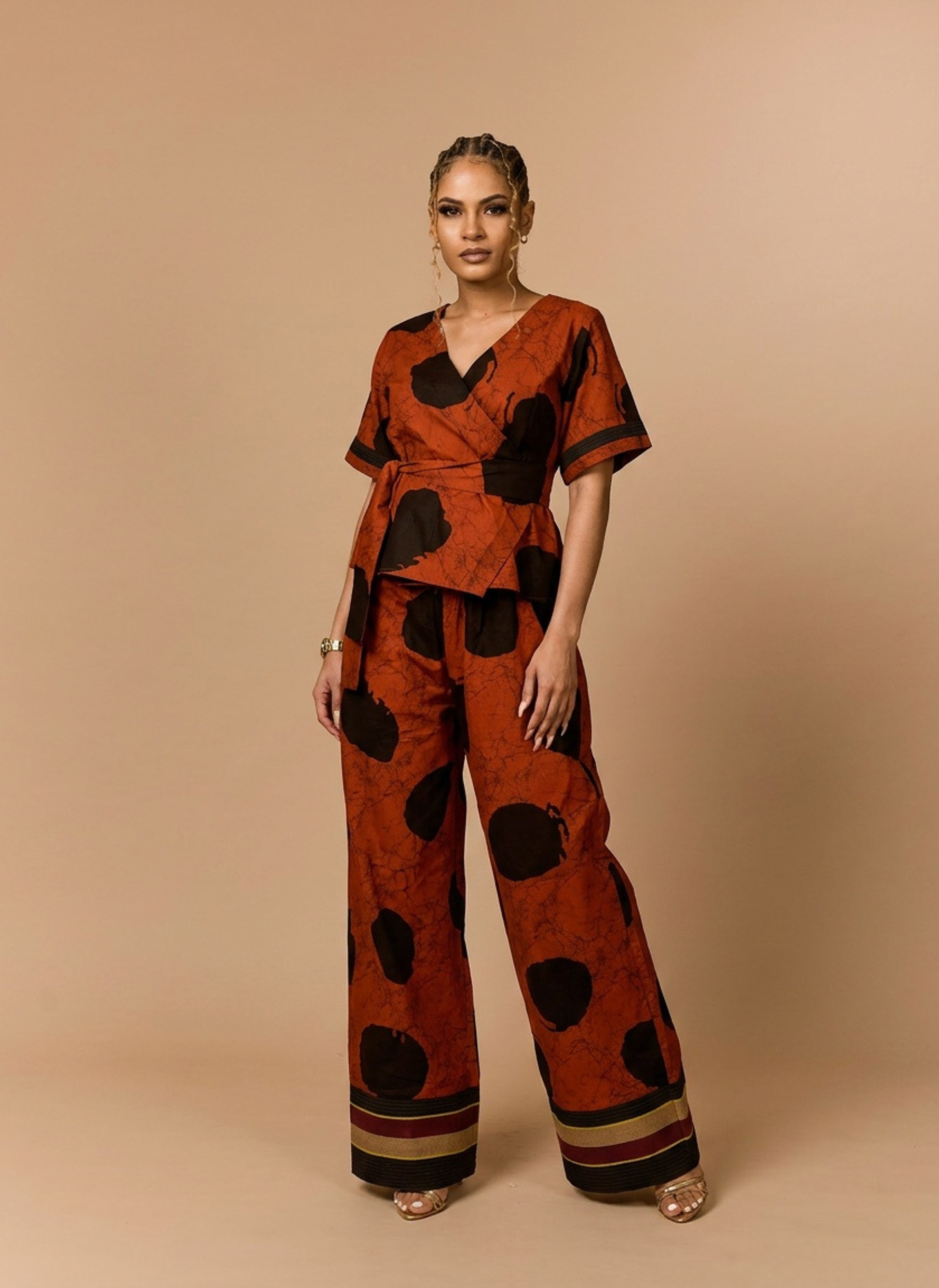 Woman wearing a brown and black patterned outfit on a beige background