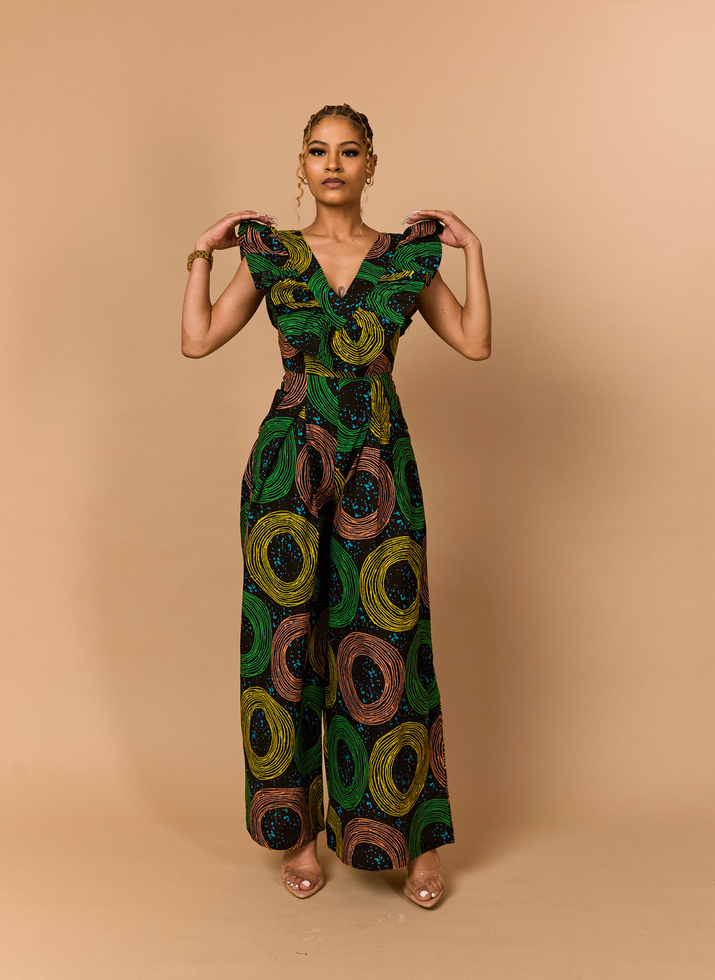 Elegant woman posing in a green African print jumpsuit, ideal for galas and special occasions.