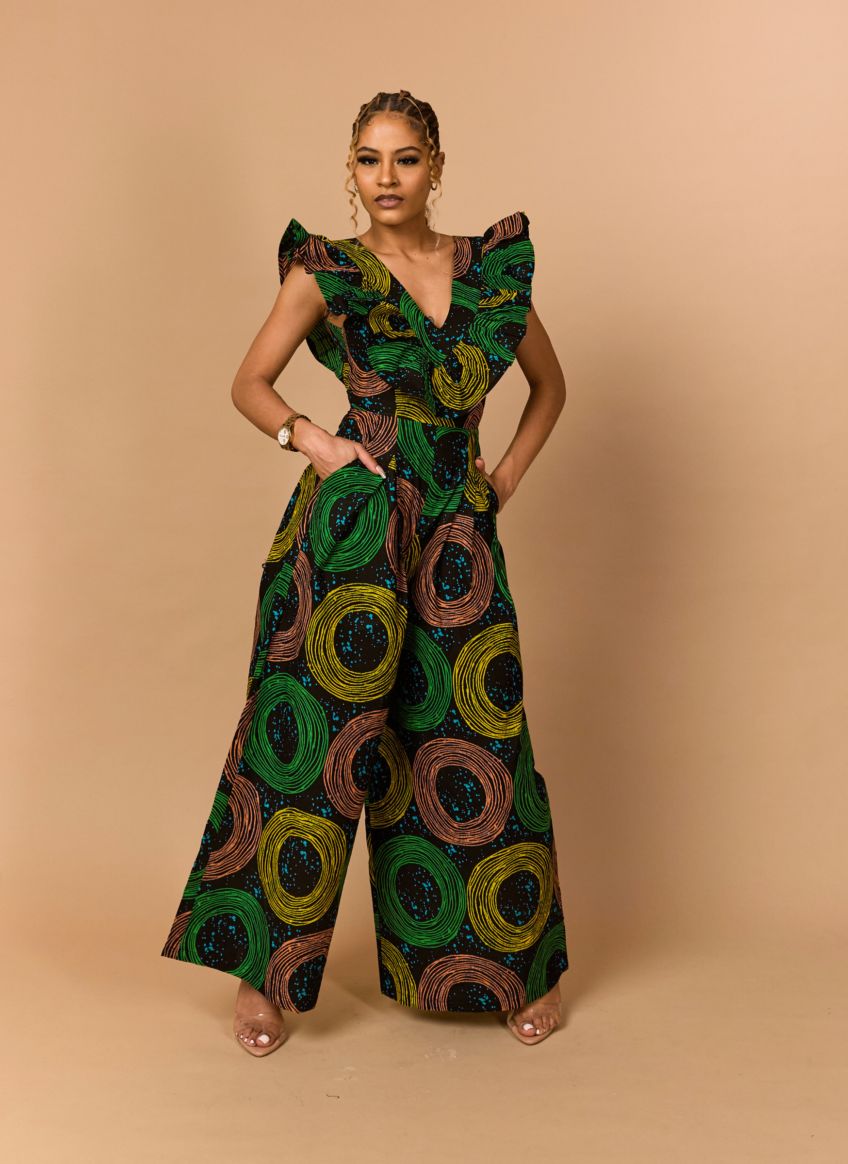 Structured side view of a designer Ankara jumpsuit with a cinched waist and high-fashion silhouette.