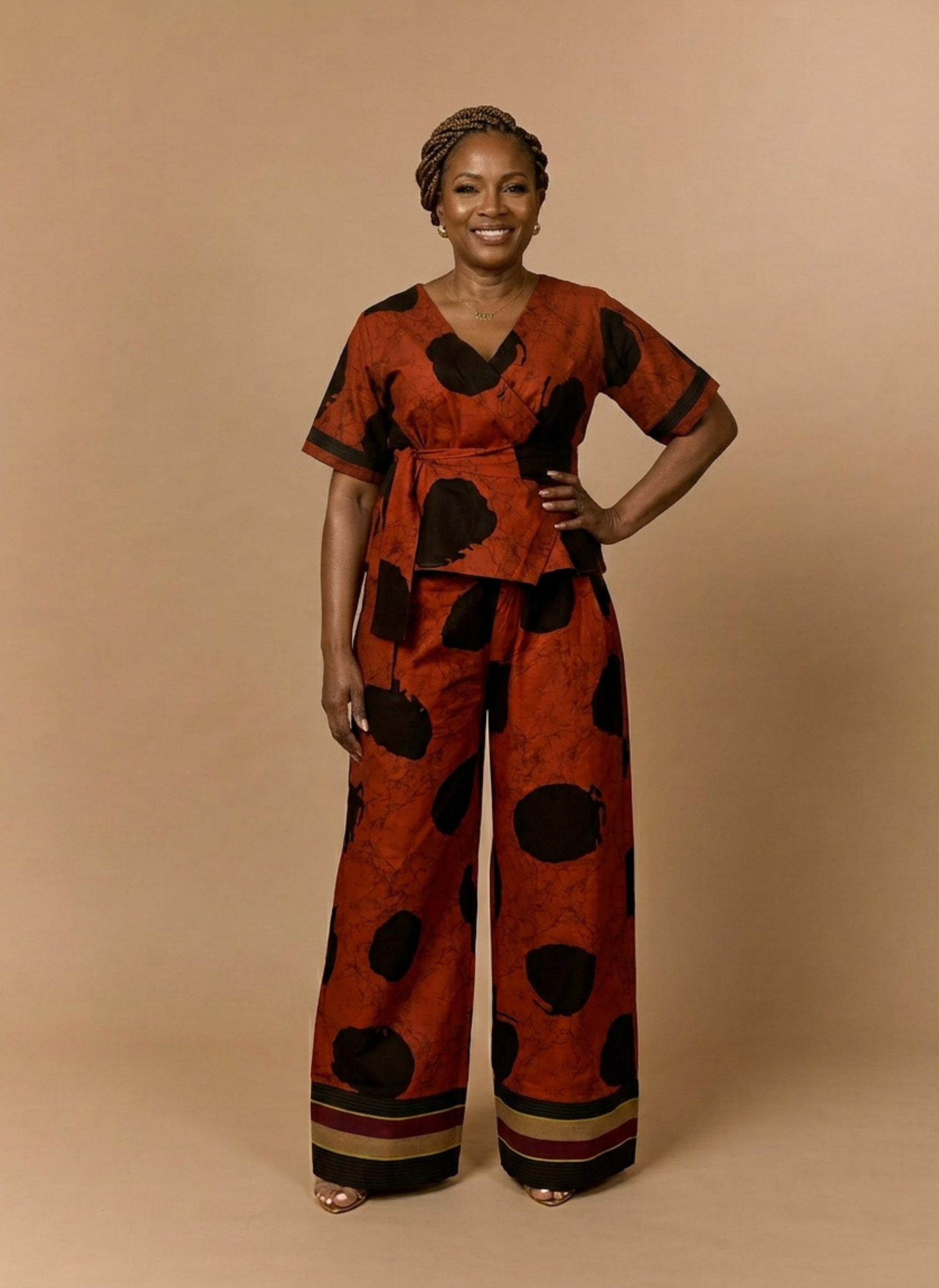 Woman wearing a red and black patterned outfit on a beige background
