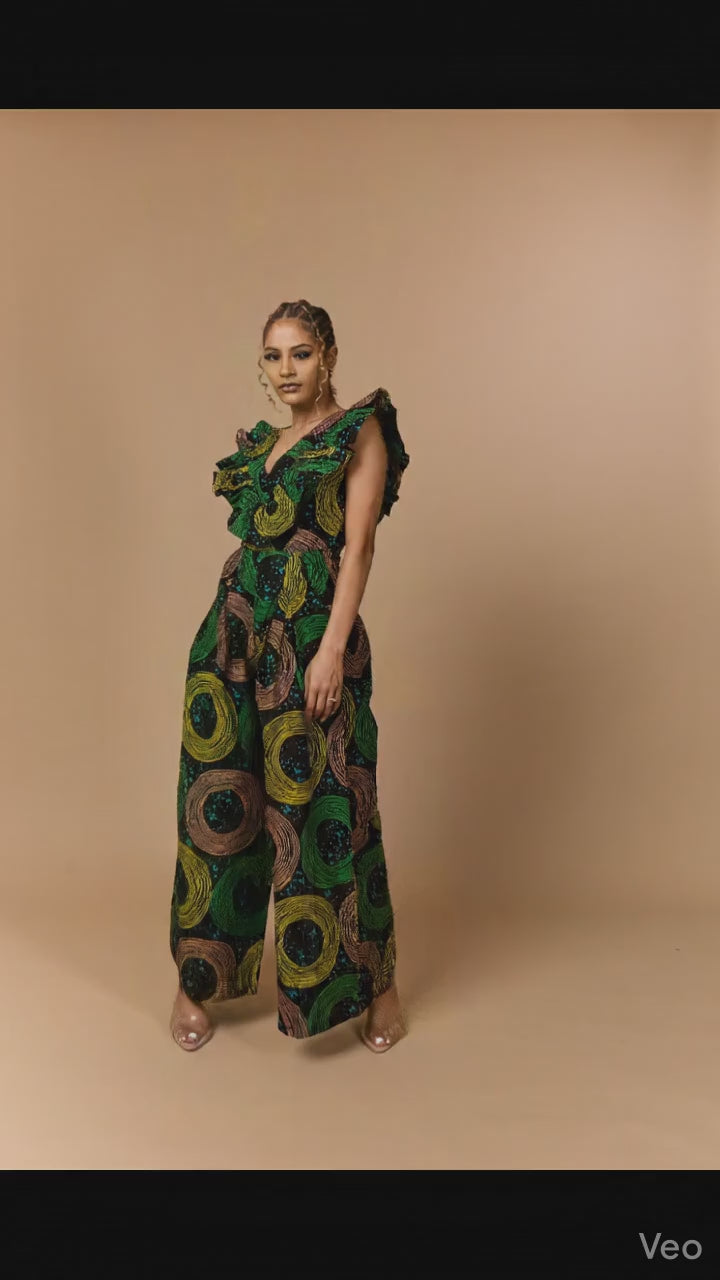 Close-up of premium cotton Ankara fabric on a wide-leg jumpsuit with vibrant green circular patterns.