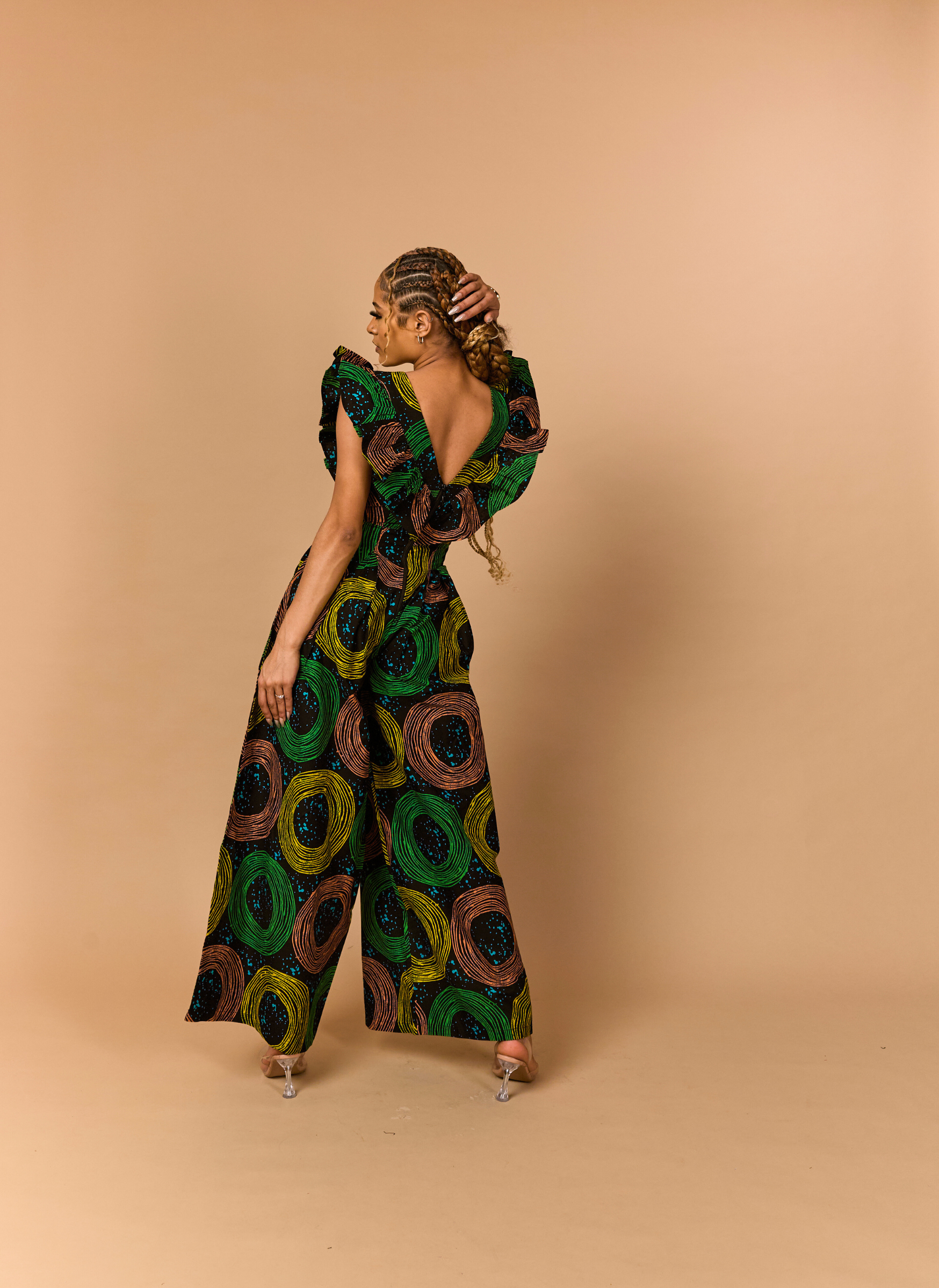Rear view of a tailored wide-leg Ankara jumpsuit highlighting the seamless fit and concealed zipper.